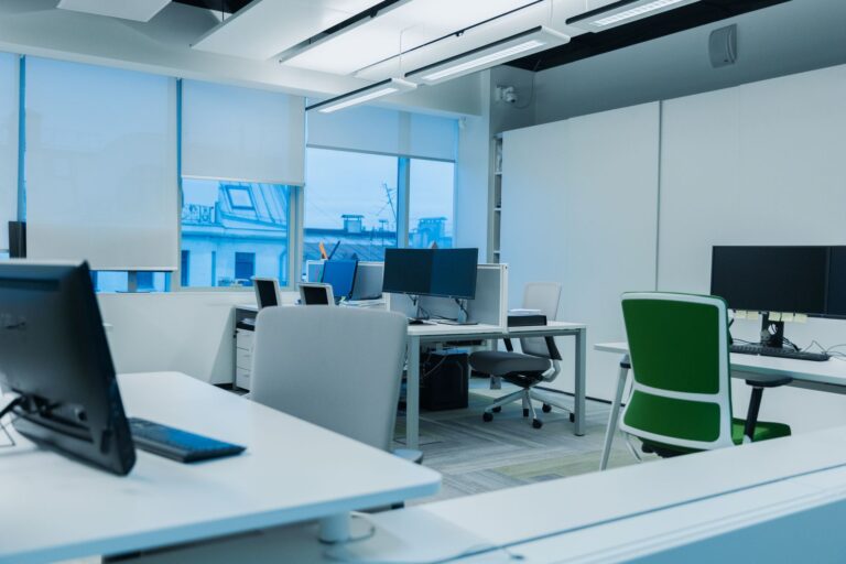 Bright modern office with matching computer workstations arranged near large windows